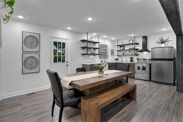 dining area featuring wood-type flooring and sink