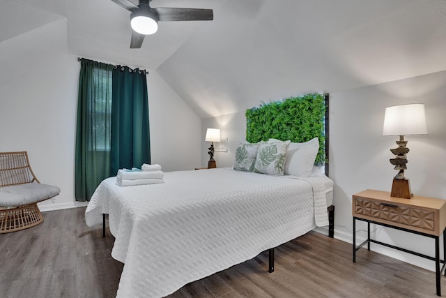 bedroom featuring ceiling fan, hardwood / wood-style floors, and vaulted ceiling