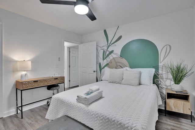 bedroom with ceiling fan and hardwood / wood-style flooring