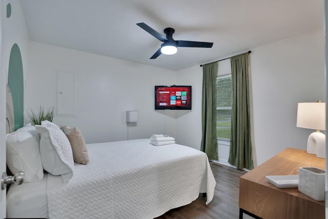 bedroom with ceiling fan and dark hardwood / wood-style floors