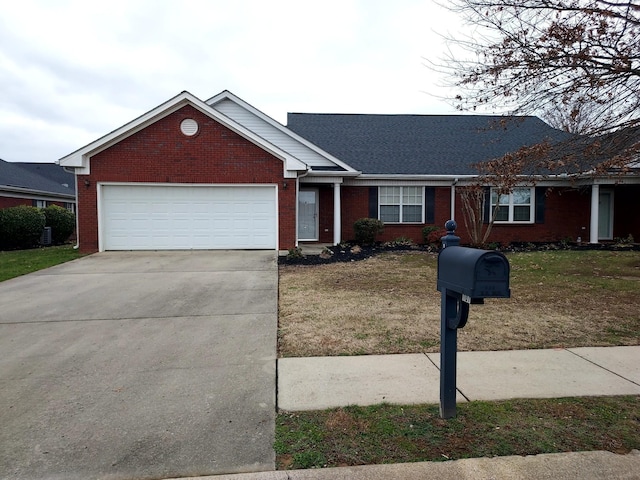 ranch-style home featuring a front lawn and a garage