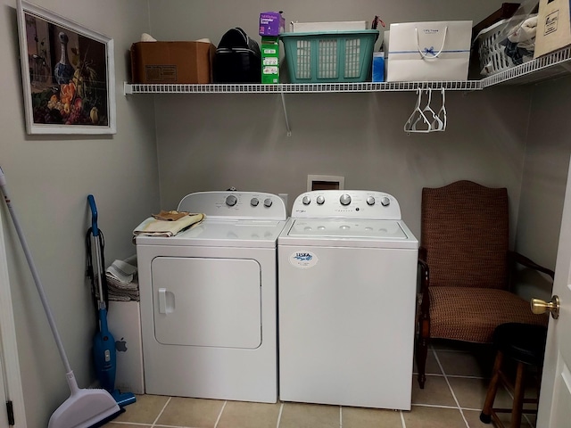 laundry room featuring washer and dryer and light tile patterned flooring