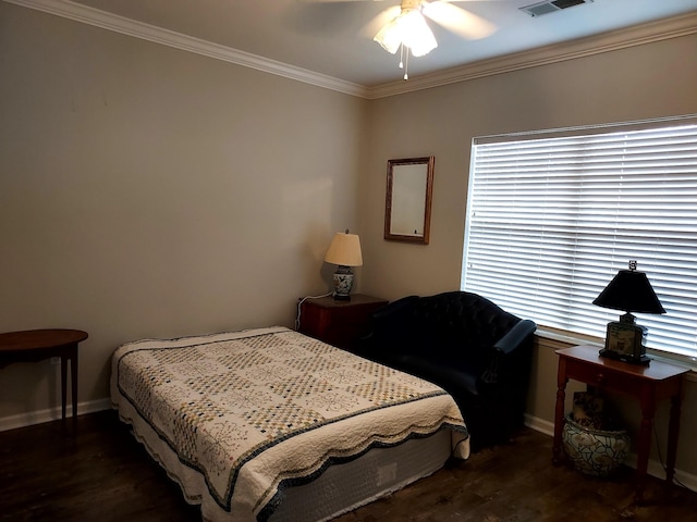 bedroom with ceiling fan, crown molding, and dark wood-type flooring