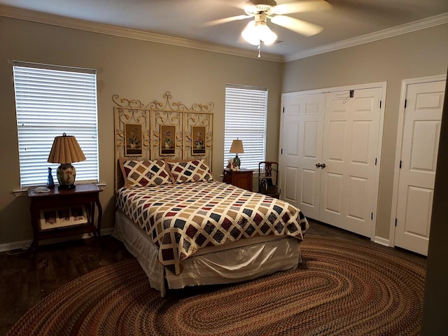 bedroom with multiple windows, dark hardwood / wood-style floors, ceiling fan, and ornamental molding