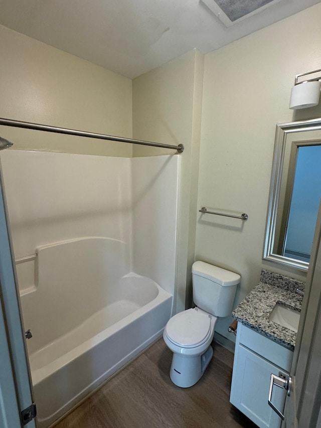 full bathroom with bathtub / shower combination, wood-type flooring, vanity, and toilet