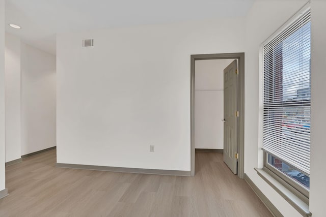 empty room featuring a wealth of natural light and light hardwood / wood-style floors