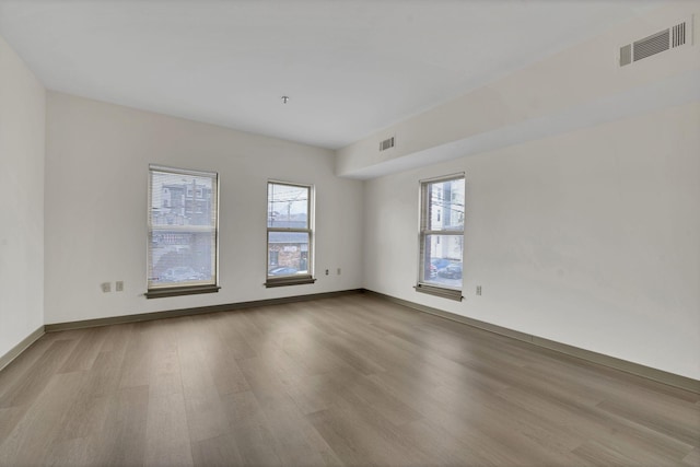 spare room with light hardwood / wood-style flooring