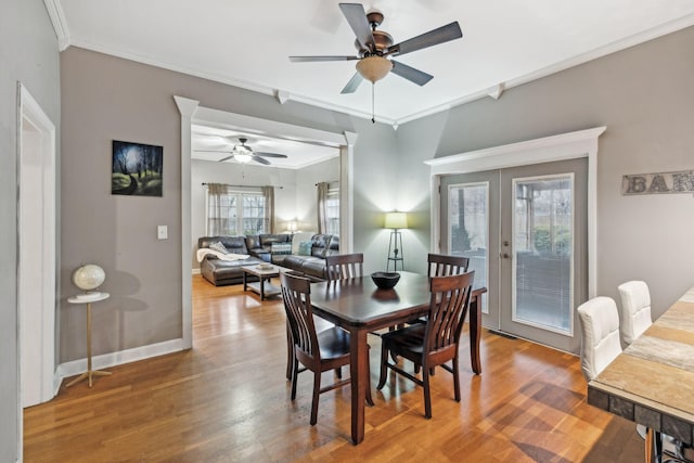 dining space featuring crown molding, french doors, ceiling fan, and hardwood / wood-style floors