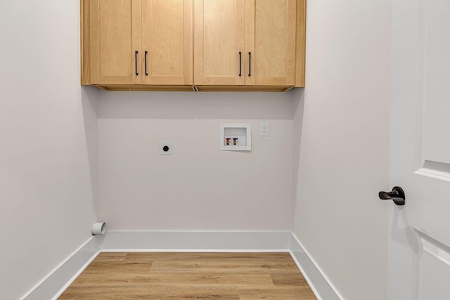 laundry room featuring hookup for an electric dryer, hookup for a washing machine, light wood-type flooring, and cabinets