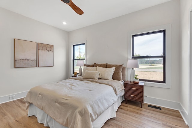 bedroom with ceiling fan and light hardwood / wood-style floors