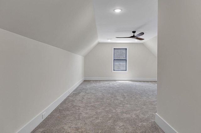 additional living space featuring ceiling fan, carpet floors, and vaulted ceiling