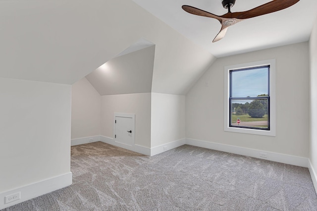 additional living space featuring ceiling fan, light carpet, and lofted ceiling