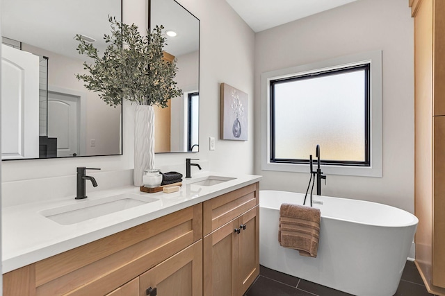 bathroom featuring vanity, a tub to relax in, and tile patterned floors