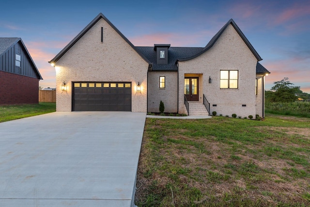 view of front of property with french doors, a yard, and a garage