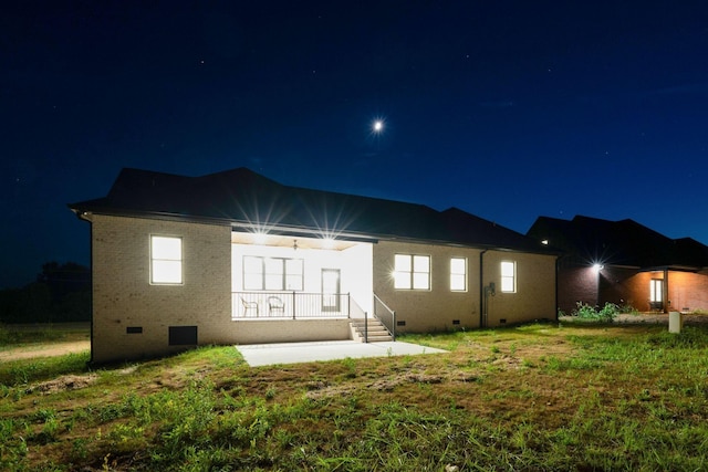 view of back house at twilight