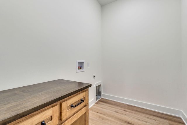 laundry area with hookup for a washing machine, cabinets, light wood-type flooring, and hookup for an electric dryer