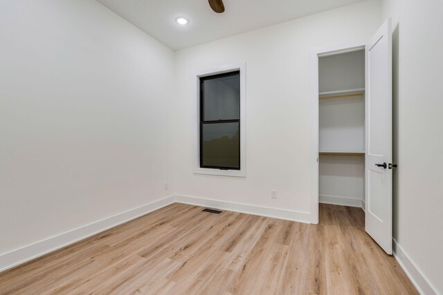 unfurnished bedroom featuring light wood-type flooring and ceiling fan