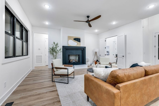 living room featuring ceiling fan and light wood-type flooring