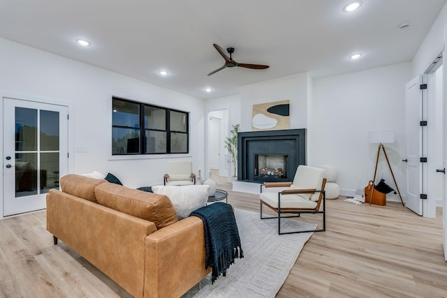 living room with ceiling fan and light hardwood / wood-style floors