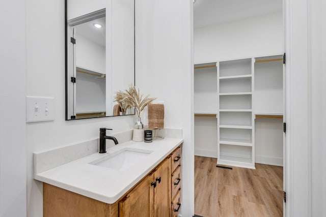 bathroom with vanity and hardwood / wood-style flooring