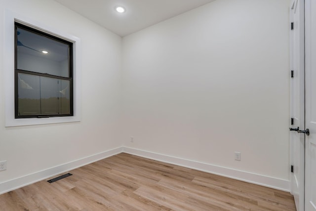 spare room featuring light hardwood / wood-style flooring