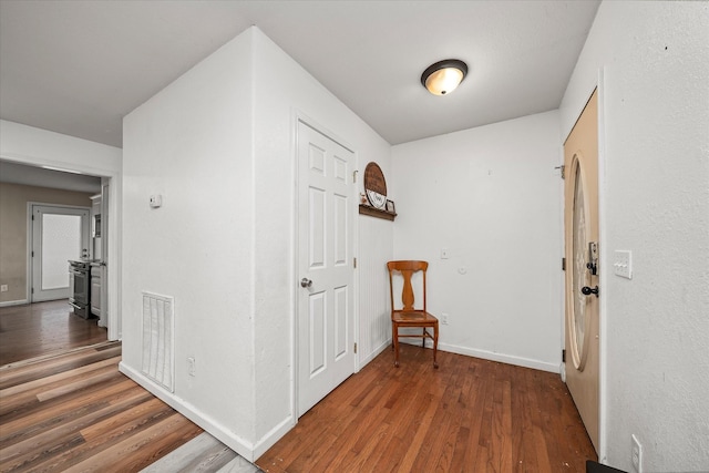 hallway with dark wood-type flooring