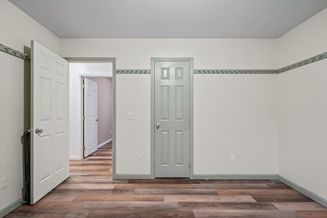 unfurnished bedroom featuring dark hardwood / wood-style flooring