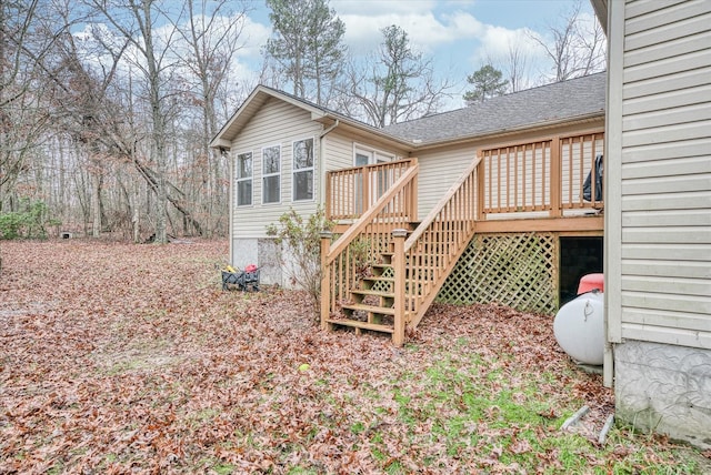 rear view of house featuring a wooden deck