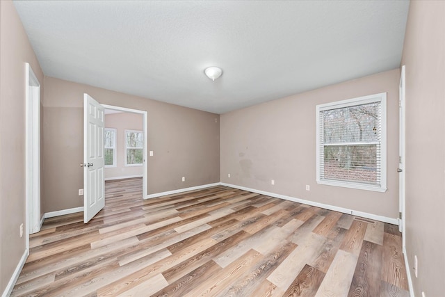 spare room featuring light hardwood / wood-style flooring