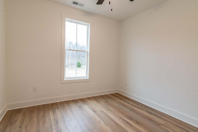 spare room featuring light hardwood / wood-style floors and ceiling fan