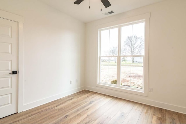 spare room with ceiling fan and light wood-type flooring