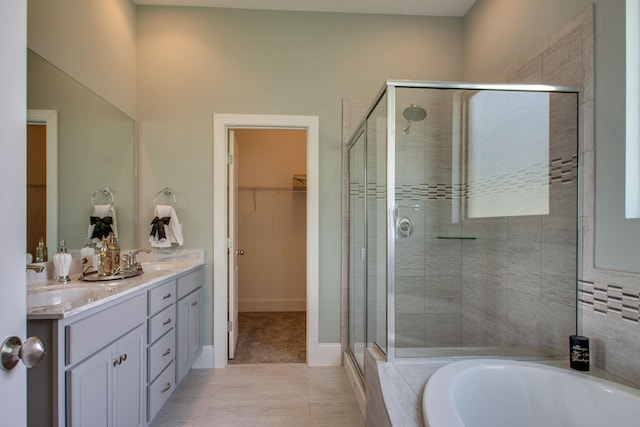 bathroom with tile patterned floors, separate shower and tub, and vanity