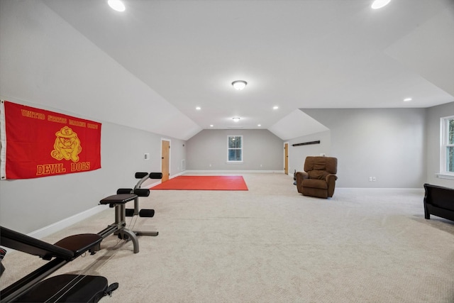 workout room with light carpet and lofted ceiling