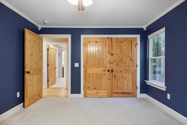 carpeted bedroom with ceiling fan and ornamental molding