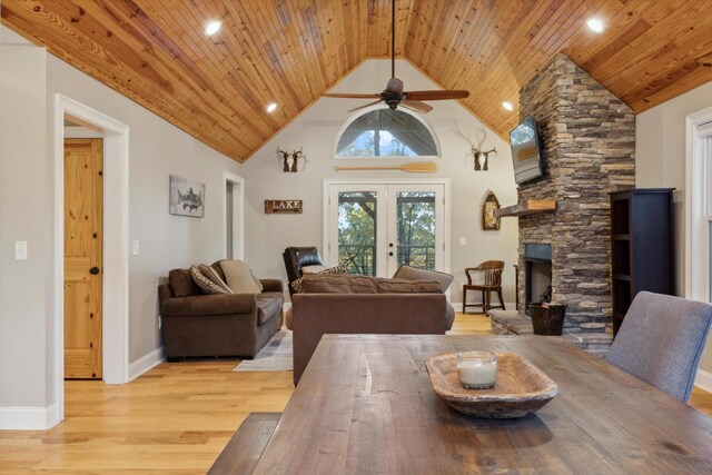 dining area featuring ceiling fan, french doors, high vaulted ceiling, light hardwood / wood-style floors, and wood ceiling