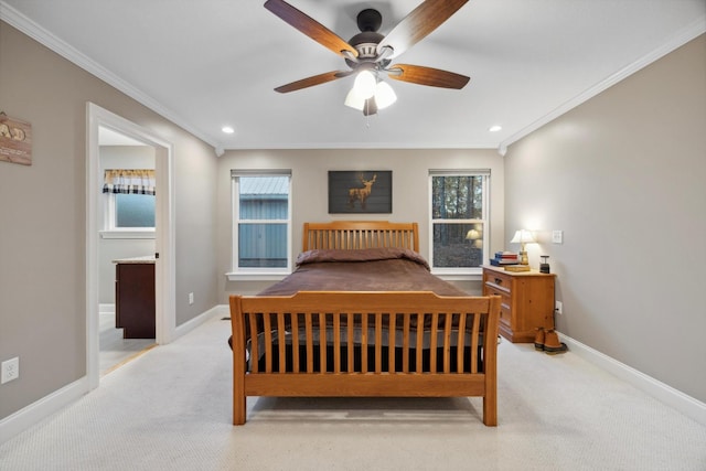 carpeted bedroom featuring ceiling fan and crown molding