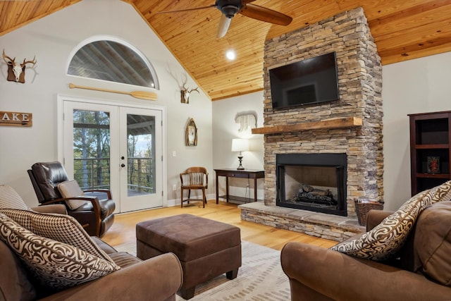 living room with french doors, light wood-type flooring, wood ceiling, high vaulted ceiling, and a stone fireplace