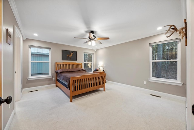 bedroom featuring ceiling fan, crown molding, and light carpet