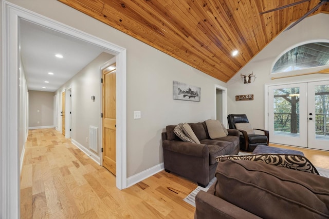 living room with vaulted ceiling, light hardwood / wood-style floors, wood ceiling, and french doors