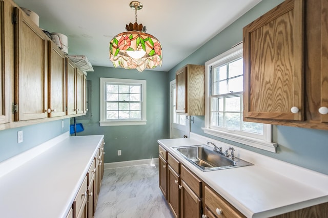 kitchen with decorative light fixtures and sink