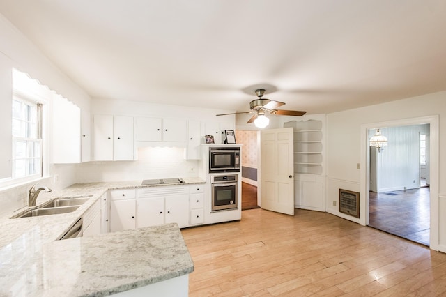 kitchen featuring black appliances, white cabinets, sink, light stone countertops, and light wood-type flooring