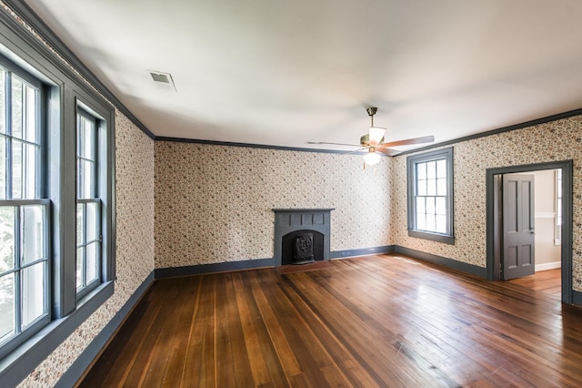 unfurnished living room featuring dark wood-type flooring, ceiling fan, and ornamental molding