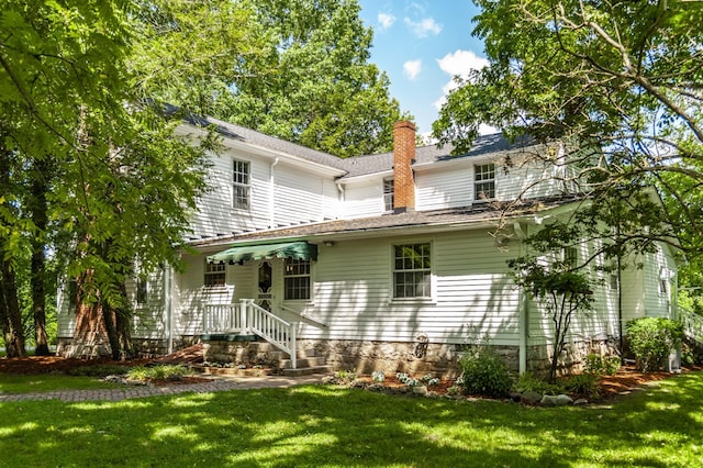 rear view of house with a yard