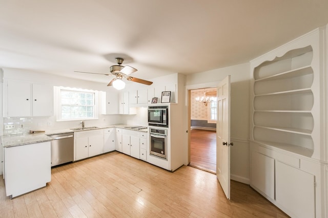 kitchen featuring white cabinetry, sink, appliances with stainless steel finishes, and tasteful backsplash