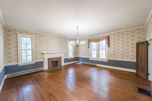 unfurnished living room featuring dark hardwood / wood-style flooring, crown molding, and a baseboard heating unit