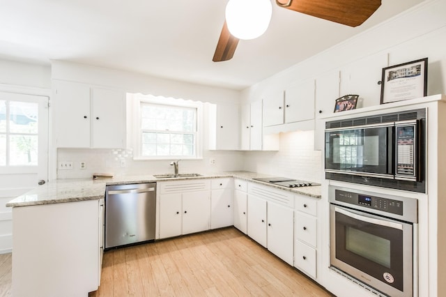 kitchen featuring sink, white cabinets, and black appliances