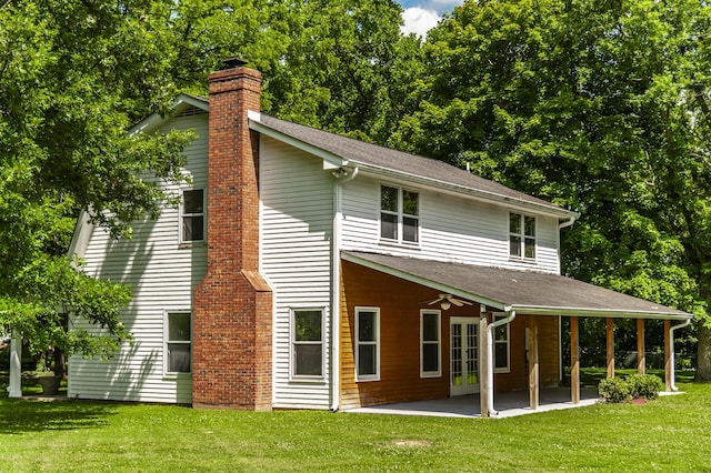 back of property featuring a lawn, ceiling fan, and a patio area