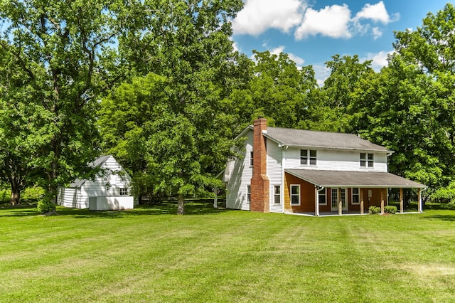 rear view of house featuring a lawn