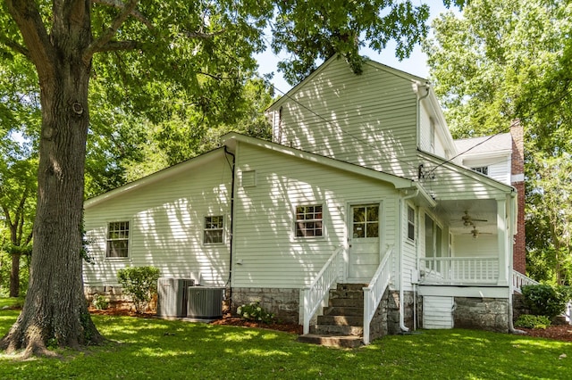 rear view of property with a lawn, ceiling fan, cooling unit, and a porch