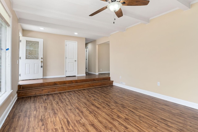 spare room with ceiling fan, beam ceiling, and dark hardwood / wood-style flooring